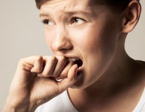 Young woman, hand to mouth, close-up